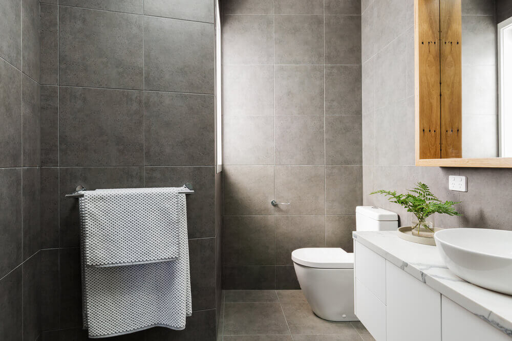image of a magazine ready bathroom with charcoal tiles and grey floors made by tiler Mandurah