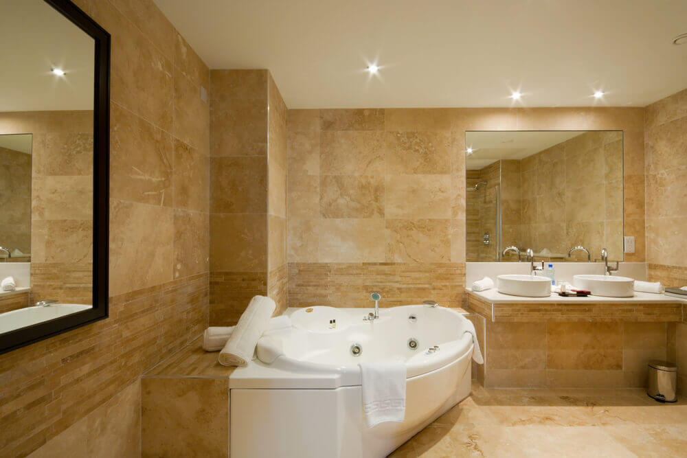 Image of a luxury bathroom with sandstone colored bathroom tiles