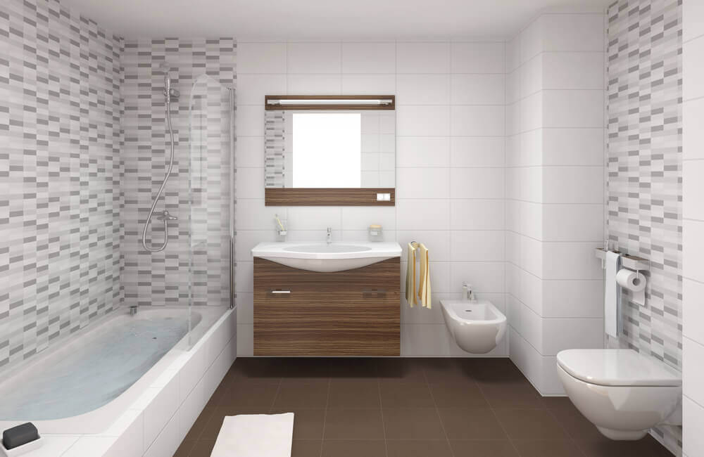 a premium bathroom with white and grey small bathroom tiles on the wall and large brown tiles on the floor